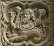 Panel 10:04 - Bearded, cowled man/basilisk hybrid carrying club and throwing a rock